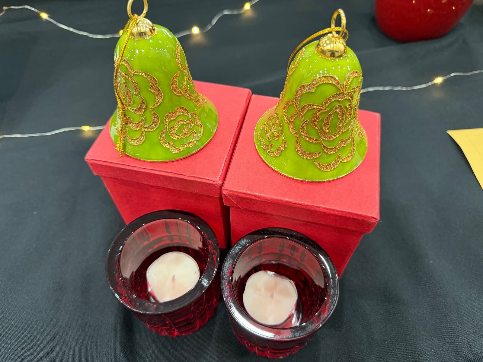 2x Green Bell decorations and 2x red glass candle holders